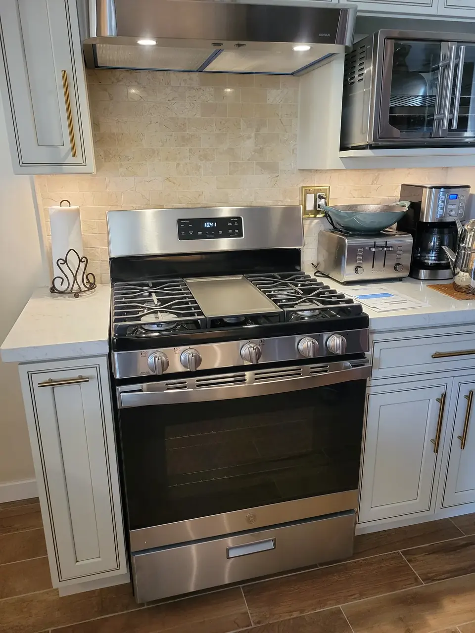 Newly installed stainless steel GE gas range in a remodeled San Diego kitchen