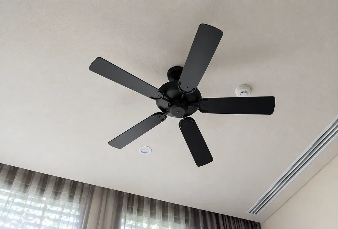 AllPro AG installed black five-blade ceiling fan mounted level on a bedroom ceiling in San Diego