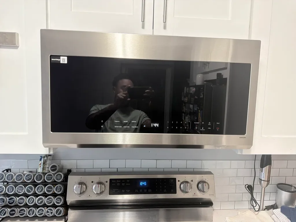 Samsung over-the-range microwave installed above a stainless range in a San Diego kitchen