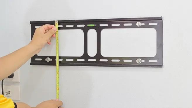 TV wall mount bracket measured and leveled before mounting in San Diego