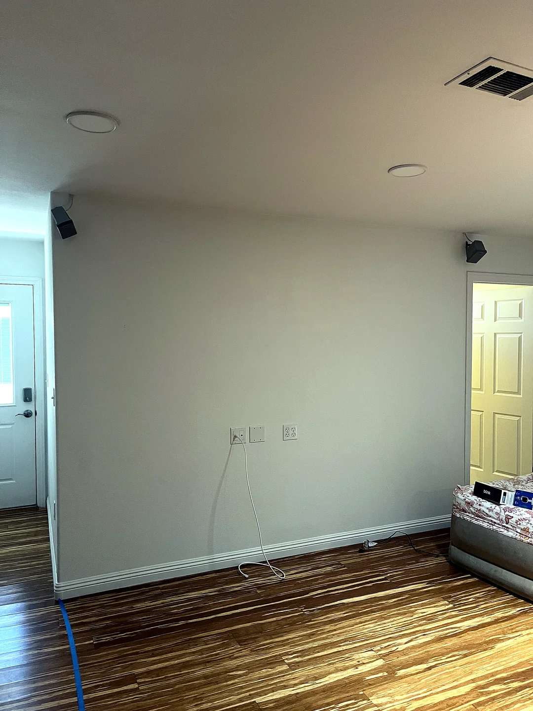 Bare living room wall before professional TV mounting and wire concealment in San Diego